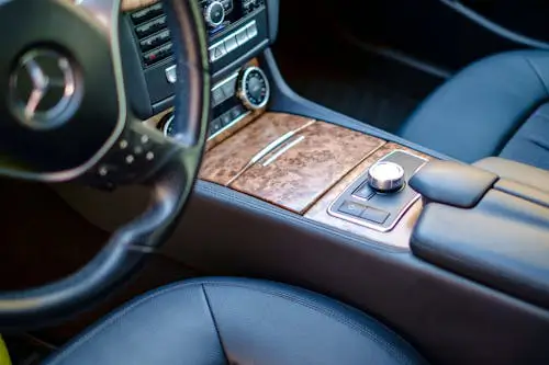 Free High-end car interior featuring leather seats and wood accents. Sleek and modern design. Stock Photo